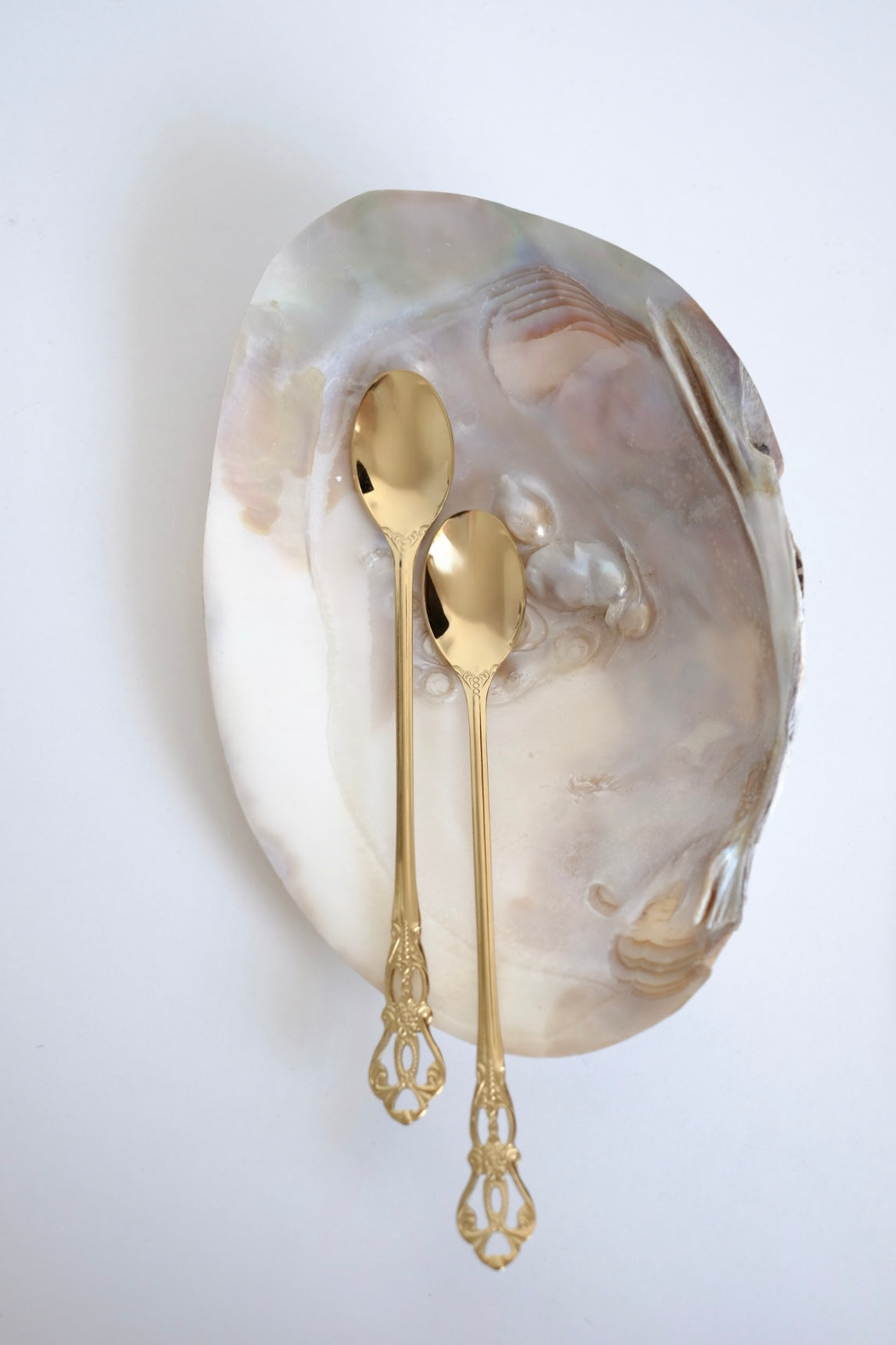 כפיות קוקטל ארוכות וינטג׳ סט של 5 כפיות ציפוי זהב עם חריטה דקורטיבית. סט של חמש כפיות בר וינטג׳ מנירוסטה ציפוי זהב. הן פריט נדיר לאוהבי מטבח בסטייל רטרו ופרטי וינטגי מיוחדים לבית. כפיות ארוכות הן כלי מטבח וינטג׳ יוקרטיים ומתאימות מושלם להגשת קינוח ועיצוב שולחן חג. הכפיות הן חלק מקולקציית כלי מטבח בסטייל ייחודי שלא רק משדרג מראה שולחן חגיגי, אלא גם מוסיף חווית ארוחה אירופאית אלגנטית של פעם. זאת מתנה נהדרת לאנשים שאוהבים פריטי אספנות נדירים ולמי שמעריך סטייל ואסתטיקה. כלי הגשה לפסח יוקרתיים, סט כלים לחג פסח ב