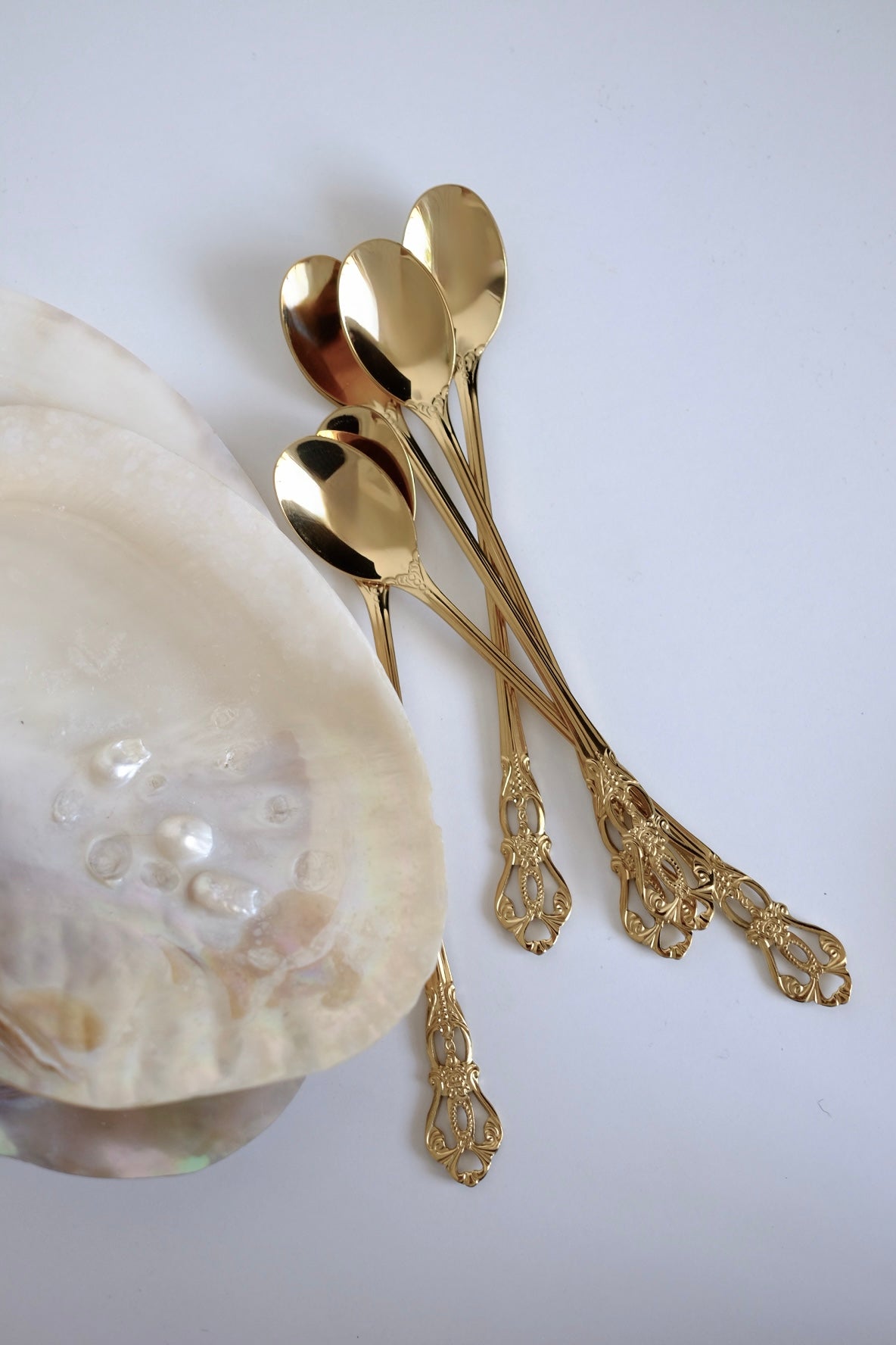כפיות קוקטל ארוכות וינטג׳ סט של 5 כפיות ציפוי זהב עם חריטה דקורטיבית. סט של חמש כפיות בר וינטג׳ מנירוסטה ציפוי זהב. הן פריט נדיר לאוהבי מטבח בסטייל רטרו ופרטי וינטגי מיוחדים לבית. כפיות ארוכות הן כלי מטבח וינטג׳ יוקרטיים ומתאימות מושלם להגשת קינוח ועיצוב שולחן חג. הכפיות הן חלק מקולקציית כלי מטבח בסטייל ייחודי שלא רק משדרג מראה שולחן חגיגי, אלא גם מוסיף חווית ארוחה אירופאית אלגנטית של פעם. זאת מתנה נהדרת לאנשים שאוהבים פריטי אספנות נדירים ולמי שמעריך סטייל ואסתטיקה. כלי הגשה לפסח יוקרתיים, סט כלים לחג פסח ב